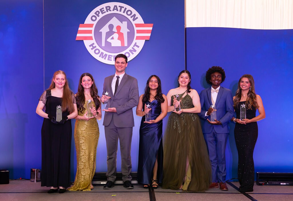 IMAGE: Seven smiling teens on stage at Military Child of the Year awards gala.